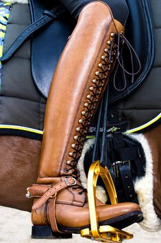 a close up of a horse's boots and saddle