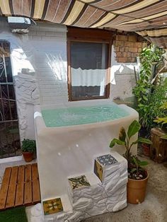 an outdoor hot tub in the middle of a patio