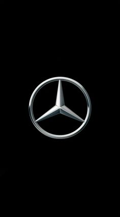 the mercedes logo is shown against a black background