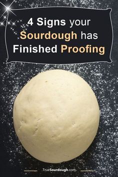 a ball of dough sitting on top of a black surface with the words 4 signs your sourdough has finished proofing