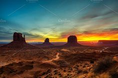 the desert landscape at sunset in monument national park, arizona usa with rock formations and dirt roads