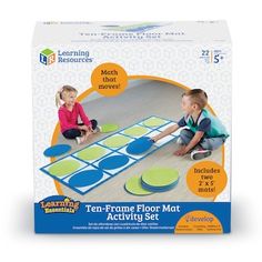 two children playing on the floor with matching mats for learning shapes and numbers, including circles