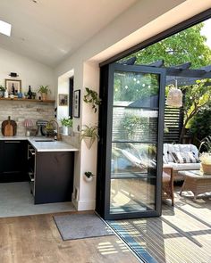 an open kitchen and living room with sliding glass doors