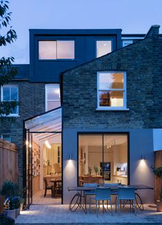 a modern house with an outdoor dining area