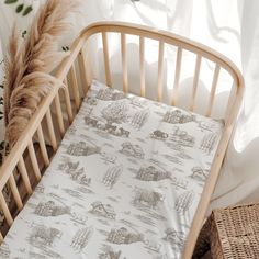 a baby crib with a white and brown bedding