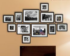 a living room with pictures on the wall and a fire place in front of it