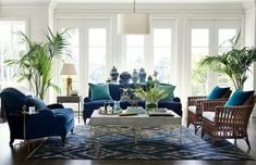 a living room filled with lots of furniture and plants in it's centerpiece