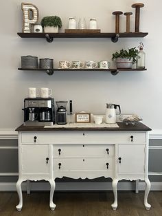 a coffee bar with two shelves above it