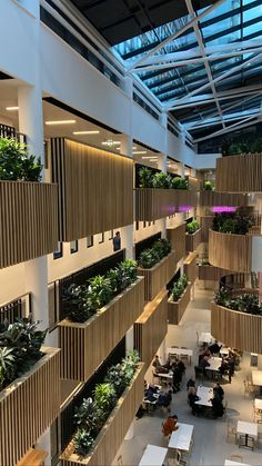 the interior of an office building with plants on the balconies