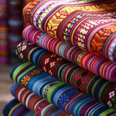 colorful fabrics are stacked on top of each other