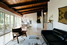 a living room filled with furniture and lots of windows