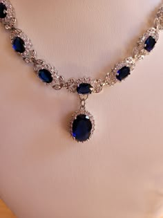 Created sapphire and diamond necklace and earring set.  Sapphire chain is 18 inches non adjustable and comes with a one inch extender.  Sapphires are 3mm oval and center stone is 7mm oval.  Diamond accents.  Earrings are two inches with a 1.75 inch drop.  7mm oval center stone.  Set in stamped 925 silver. Blue Sapphire Necklace Gold, Oval Jewelry With 17 Jewels For Evening, Elegant Sapphire Jewelry With Hand Set, Elegant Sapphire Jewelry For Party, Elegant Oval Jewelry For Evening, Elegant Sapphire Necklace With Hand-set Details, Elegant Sapphire Necklace With Hand Set Details, Teardrop Jewels Jewelry For Formal Occasions, Exquisite Oval Jewelry For Evening