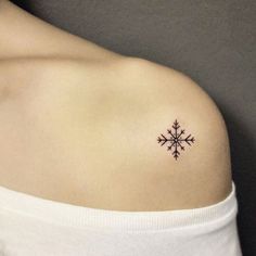 a snowflake tattoo on the left shoulder