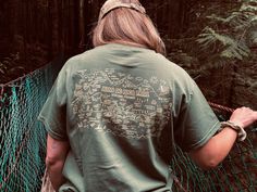 Hand drawn Juan de Fuca Trail Map printed on a 100% Cotton T-shirt, designed an produced in Port Renfrew, Vancouver Island. Reminisce on your hiking adventure! This intricately drawn map captures the essence of the amazing highlights found along this stunning coastal hike, recapturing all your memories on trail. This product is made especially for you at Childs Collective custom printing in Port Renfrew, which is why it takes us a bit longer to deliver it to you. If I don't have your size in sto Graphic Print Short Sleeve Top For Camping, Relaxed Fit Screen Print Tops For Outdoor Activities, Crew Neck Screen Print Tops For Camping, Custom Print Short Sleeve Top For Outdoor, Outdoor Short Sleeve Tops With Custom Print, Green Screen Print Top For Adventure, Green Short Sleeve Top For Camping, Adventure Short Sleeve Shirt With Screen Print, Short Sleeve Screen Print Adventure Shirt