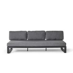 a gray couch sitting on top of a white floor