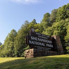 the sign for shenandoah national park is in front of some trees