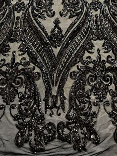 black and silver beaded fabric with an intricate design