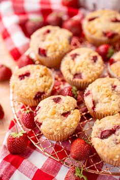 strawberries and muffins on a red checkered tablecloth