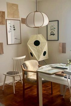 a living room filled with furniture and pictures hanging on the wall next to a window