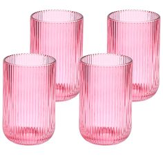 four pink glass tumblers sitting next to each other