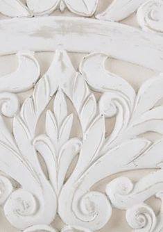 an ornate white painted piece of furniture