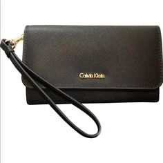 Calvin Klein Saffiano Flap Wristlet In Black New With Tags Genuine Leather Flap Closure Modern Wristlet With Wrist Strap, Chic Evening Wallet With Wrist Strap, Elegant Wristlet With Adjustable Strap For Travel, Classic Rectangular Wristlet For Evening, Classic Evening Wristlet, Classic Rectangular Evening Wristlet, Lululemon Tights, Calvin Klein Handbags, Calvin Klien