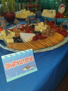 there is a platter of food on the table with shark flags and other foods