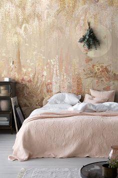 a bedroom with floral wallpaper and bedding in pastel pink, white and gold colors