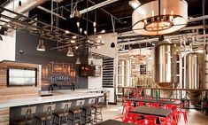 the interior of a restaurant with tables and stools