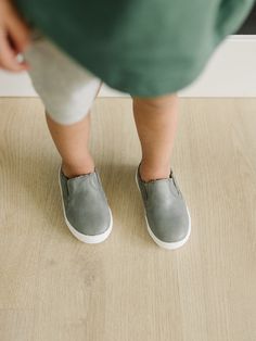 Step into effortless style and comfort with our Gray Slip-On Sneakers, available in US sizes 5-10. These versatile sneakers combine the ease of slip-on design with a sturdy hard sole, making them perfect for any occasion. Crafted from high-quality materials, they offer a blend of durability, comfort, and sleek style. Key Features: Modern Design: The sleek gray color and minimalist design make these slip-on sneakers a chic addition to any wardrobe, suitable for both casual and semi-formal wear. P Versatile Sneakers, Black Slip On Sneakers, Soft Sole Baby Shoes, Semi Formal Wear, Classic Boots, Comfortable Sneakers, On Sneakers, Classic Shoes, Sleek Fashion