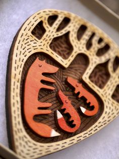 a wooden brooch with an animal design on it