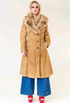 Discover timeless elegance with our Penny Lane Coat, a luxurious women's fur coat that perfectly blends vintage charm and modern style. This shearling coat features a genuine suede leather exterior and an original shearling lining, providing exceptional warmth and comfort. In a rich brown hue, this long coat evokes the iconic fashion of the 80s, offering a sophisticated trench coat silhouette. Inspired by traditional Afghan coats, it embraces a boho aesthetic perfect for winter. Crafted from hig Classic Sheepskin Fur Coat For Winter, Classic Sheepskin Coat With Faux Fur Trim, Classic Fur Coat With Faux Fur Lining For Fall, Classic Sheepskin Fur Coat With Faux Fur Trim, Classic Fall Fur Coat With Faux Fur Lining, Classic Long Faux Fur Coat, Classic Long Sheepskin Fur Coat, Vintage Shearling Fur Coat With Faux Fur Trim, Vintage Faux Fur Coat For Cold Weather