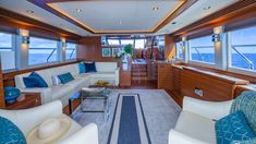 the inside of a boat with couches and chairs