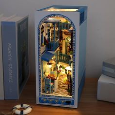 an open refrigerator sitting on top of a wooden table next to a book and toy