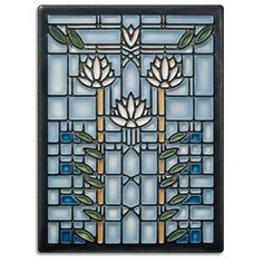 a stained glass window with flowers and leaves on it's side, in blue tones