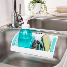 a kitchen sink with soap, sponges and other cleaning products in the drainer