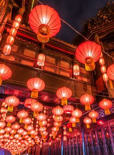 many red lanterns are hanging from the ceiling