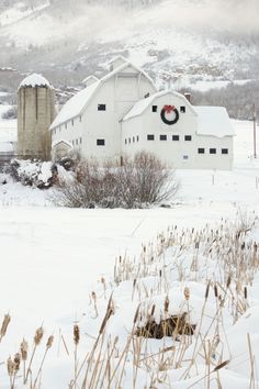 a white barn with a wreath on the front