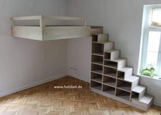 an empty room with some shelves and stairs