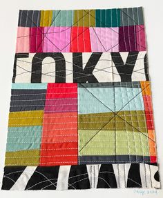 a piece of fabric with the word tokyo printed on it's side, in multicolored squares