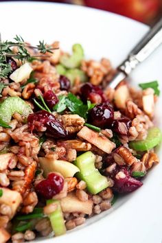 a white plate topped with fruit and nuts