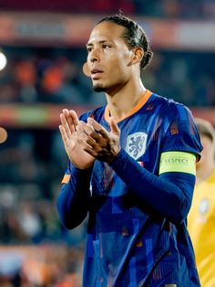 a soccer player is applauding with his hands together