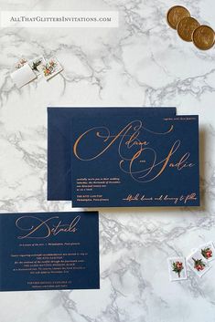 the wedding stationery is set on top of a marble countertop with gold lettering