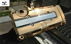 an old gold camera sitting on the hood of a car