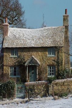 an old stone house covered in snow