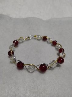 This lovely, yet simple, braided bracelet is made of clear quartz and red glass braided with gold and silver dipped wire. Friend Crafts, Braided Bracelet, Wire Bracelet, Braided Bracelets, Red Glass, Friday Night, Clear Quartz, Gold And Silver, Jewelry Bracelets