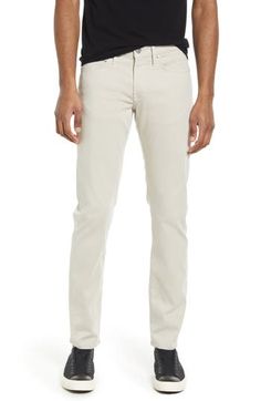 A sharp balance of casual and elevated, these slim-tailored pants keep you comfy in super-stretchy brushed twill sourced from breathable, sustainable fibers. 32 1/2" inseam; 14 1/2" leg opening; 10" front rise Zip fly with button closure Five-pocket style 74% lyocell, 17% cotton, 7% elasterell-p, 2% elastane Machine wash, tumble dry Made in Turkey Men's Clothing Slim Fitted Pants With Five Pockets, Modern Beige Bottoms With Straight Hem, Classic Slim Cotton Bottoms, Classic Slim Cotton Pants, Fitted Beige Jeans With Tapered Leg, Fitted Beige Tapered Leg Jeans, Slim Cotton Pants With Pockets, Slim Cotton Bottoms With Five Pockets, Slim Fall Pants With Pockets