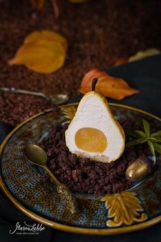 a plate with some food on it that is shaped like an egg and has leaves around it