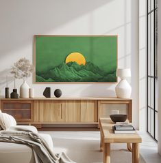 a living room filled with furniture and a painting hanging on the wall over a coffee table