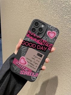 a person holding up a cell phone case with the words happiness good day on it